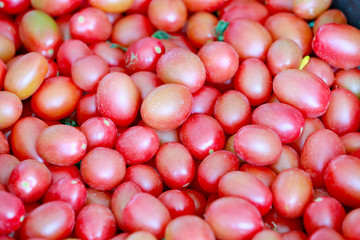 Many fresh tomatoes piled up together