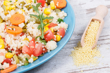 Fresh salad with couscous and vegetables. Light dietary vegan meal