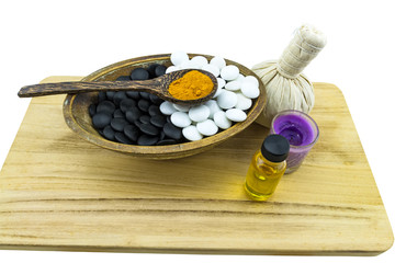 Close up ball compressing spa and black and white stone with aroma candle present in Yin - Yang spa concept isolate on white background.Saved with clipping path.