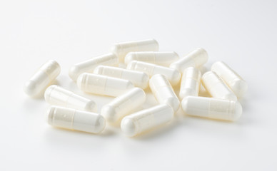 White capsules placed on a white background