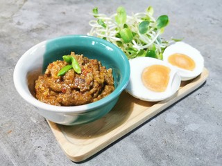 Crab Chili Paste in mini green cup with Boiled Eggs , Vegetable on wooden plate