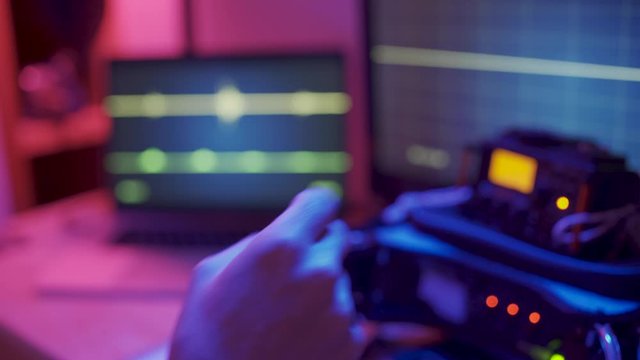 Close up hand counting down from 3 to 1 - TV show control room and monitors