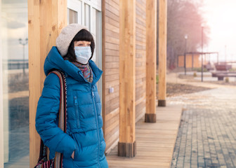 A woman in a medical mask on the street during a coronavirus.