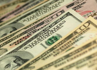 Colorful background with money US dollars of different value. Top view of business concept with finance for banks. American banknotes 5, 10, 50, 100 dollars backdrop