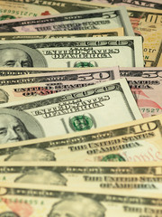 Colorful background with money US dollars of different value. Top view of business concept with finance for banks. American banknotes 5, 10, 50, 100 dollars backdrop