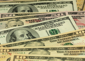 Colorful background with money US dollars of different value. Top view of business concept with finance for banks. American banknotes 5, 10, 50, 100 dollars backdrop