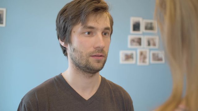 Close up face of the man. The wife slaps her husband. Family conflict