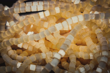 
round faceted beads with a matte and glossy finish in a low key and bokeh in the background