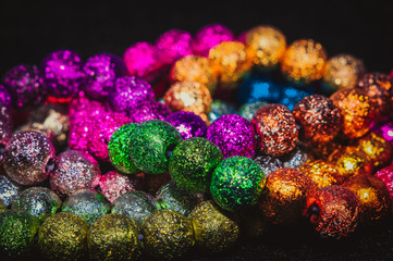 
multicolored christmas beads with boke in the background