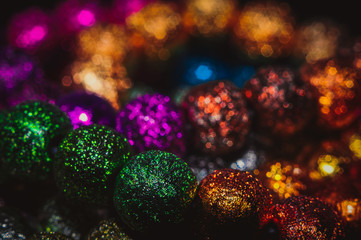 
multicolored christmas beads with boke in the background