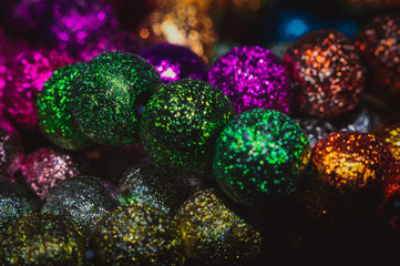 
multicolored christmas beads with boke in the background