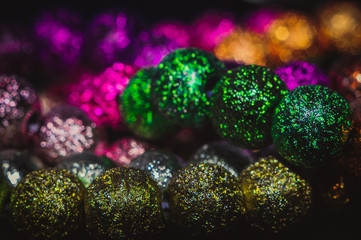 
multicolored christmas beads with boke in the background