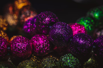 
multicolored christmas beads with boke in the background