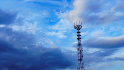 Obraz premium Panoramic view of big television and radio tower on the dramatic sky background. Space for text.