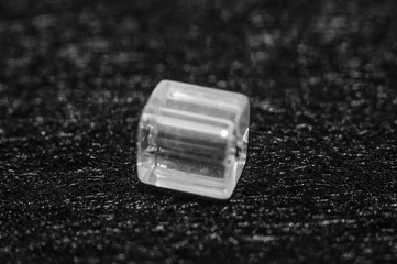 
square beads on a black textured background in low key