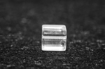 
square beads on a black textured background in low key