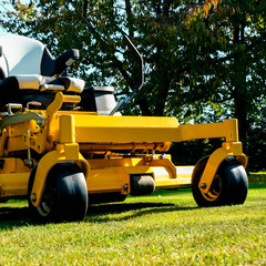 Lawn mower park in green grass field, zero turn Lawn mower.
