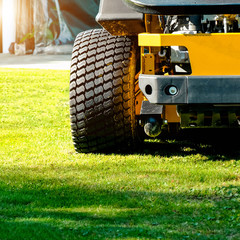 Lawn mower park in green grass field, zero turn Lawn mower.
