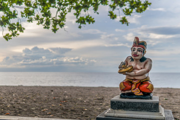 Colorful Hindu Statue at Beach with sunset in background