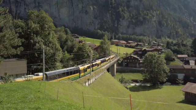 Swiss train leaving Lauterbrunnen train station headed up the valley to Wengen.