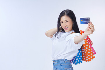 woman holding credit card and paper bags