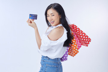 Shopping concept. Overjoyed woman holding credit card and paper bags