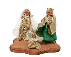 Christmas nativity scene decoration on wooden base on white background, handmade nativity scene figures with a white veil, wooden head
