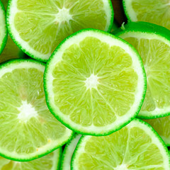 Green background with citrus-fruit of lime slices, Lemon texture
