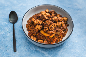 plant-based food, vegan lentil curry soup with marinated tofu cubes