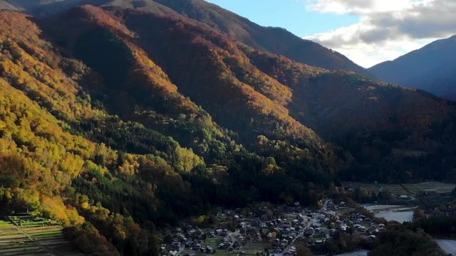 Hyperlapes by Drone shot of Aerial view over historical village Shirakawa-go village in the autumn during sunset,  Shirakawa-go is one of Japan's UNESCO World Heritage Sites.