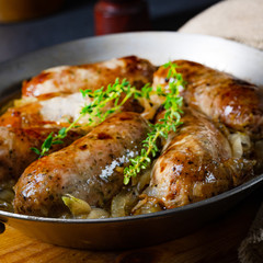 Homemade white sausage fried with onion and herbs