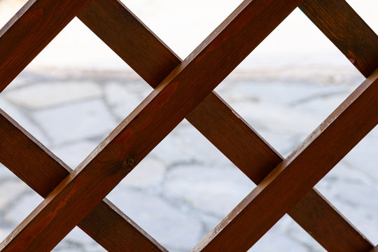 Fragment of a fence in the form of a wooden lattice