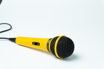 Yellow microphone isolated on white background.