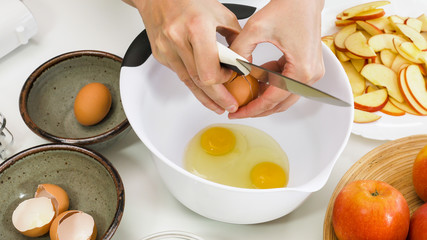 Step by step Apple pie recipe. Eggs in a bowl, close up on white background