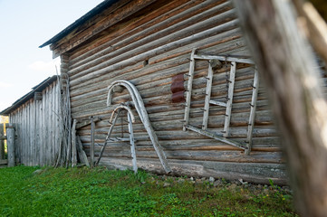 Old peasant tools hang on the wooden wall