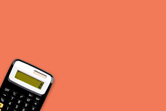 Calculator on orange color background. Business and copy space concept