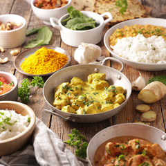 assorted of indian food- chicken tikka masala, curry lentil dal, naan bread
