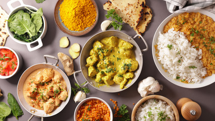 assorted of indian food- chicken tikka masala, curry lentil dal, naan bread