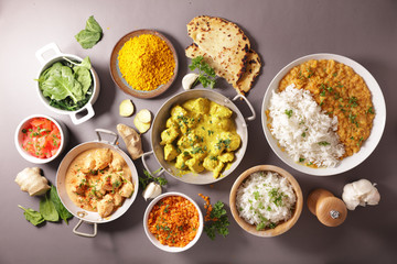 assorted of indian food- chicken tikka masala, curry lentil dal, naan bread