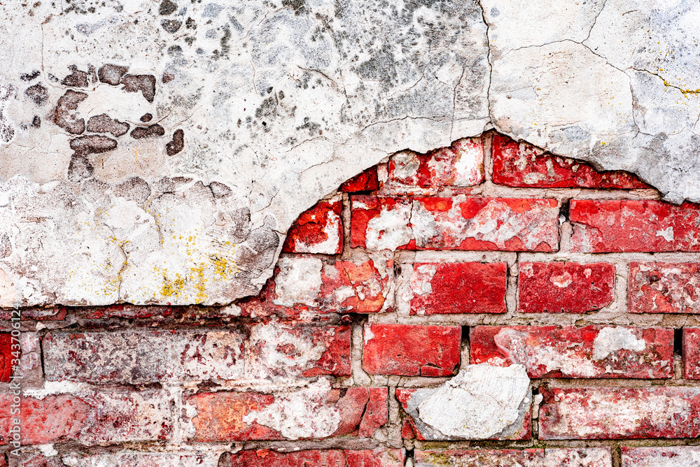 Wall mural texture of a brick wall with cracks and scratches which can be used as a background