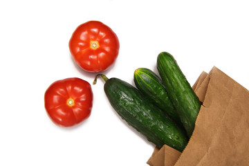 fresh vegetables tomatoes and cucumbers on a white background