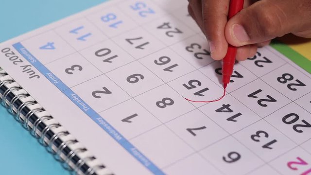 Marking July 15th tax day on calendar as reminder - Concept of file tax form before deadline july 15th