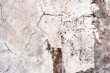 Texture of a concrete wall with cracks and scratches which can be used as a background