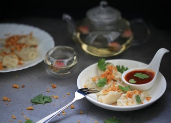 Homemade Dim sum top up with fried garlic and coriander on cement table background