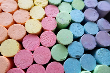 colorful chalks, pink, green, blue, violet, orange and yellow.
