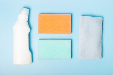 Rag and detergent on blue background, the concept of spring cleaning