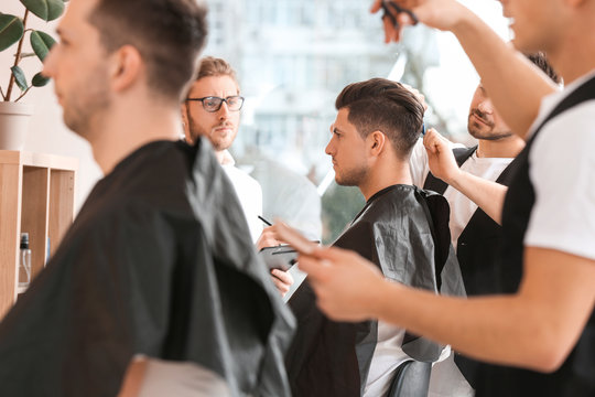 Young men during professional courses in hairdresser's salon