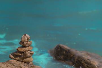 Zen concept. Object made of stone on the beach. Stone pyramid for meditation. Harmony and Meditation. Zen stones.
