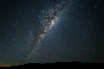 A night time photo of the Milky Way galaxy against a dark starry sky in the southern hemisphere of...
