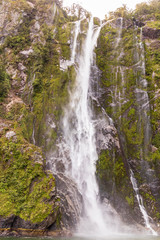 Fototapeta na wymiar Waterfall at Milford sound in New Zealand. South Island.